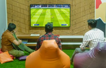a group of people sitting in front of a flat screen tv