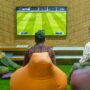 a group of people sitting in front of a flat screen tv