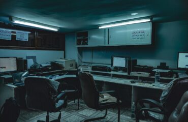 a room with computers and chairs