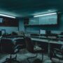 a room with computers and chairs